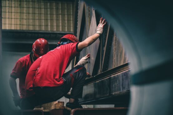 workers in red t shirts in factory