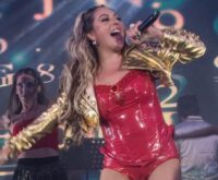 Mariana Ochoa sobre el escenario con atuendo rojo, fotografía de una presentación anterior