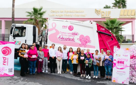 Grupo de vecinos, beneficiarias, autoridades, Perla Cavazos y Red Ambiental frente al camión rosa y Centro de Rehabilitación DIF Ciénega